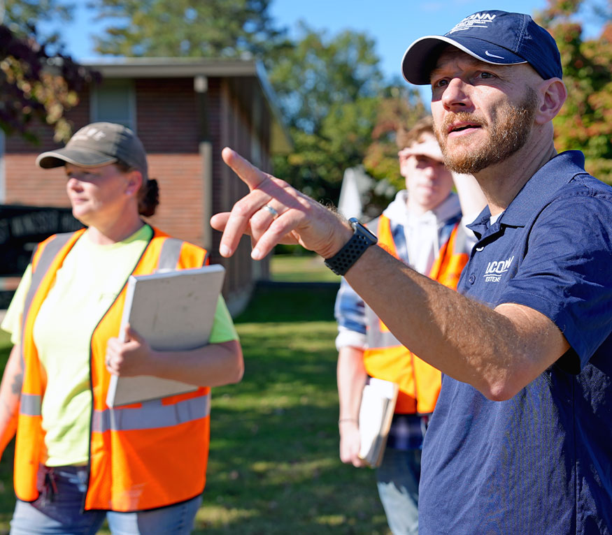 educator pointing at something off camera sight