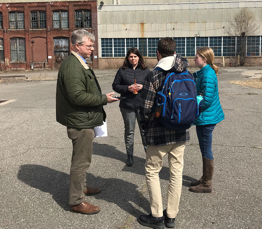 students looking at a brownfield lot