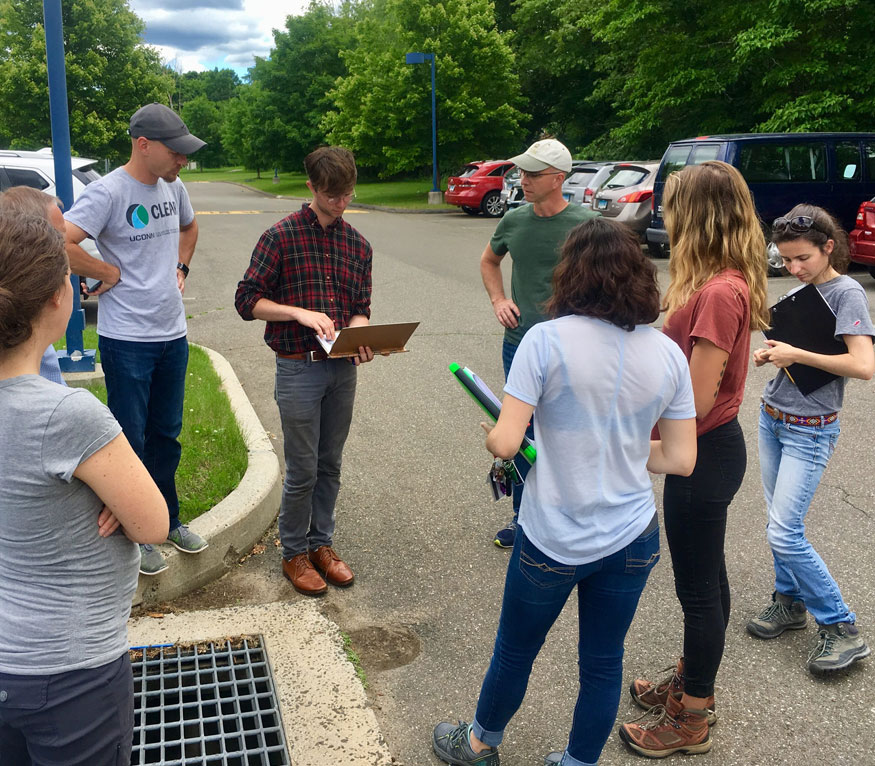 students outside near a stormwater drain